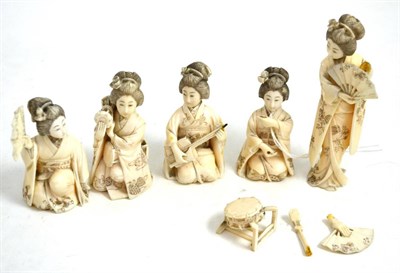 Lot 236 - Four carved ivory figures of kneeling Geishas holding fans and playing instruments and another...