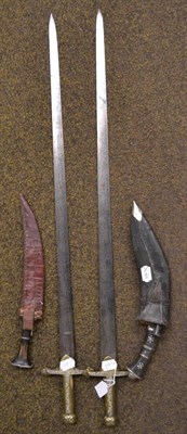 Lot 269 - A pair of brass hilted swords and two kukri with leather scabbards