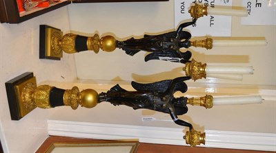 Lot 281 - A pair of French Empire gilt bronze winged angel two-branch three-light table candelabra, upon...