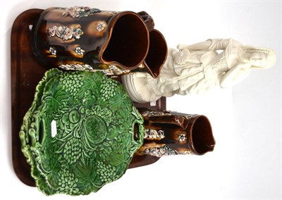 Lot 304 - Three bargeware jugs, a Parian figure and two majolica leaf dishes