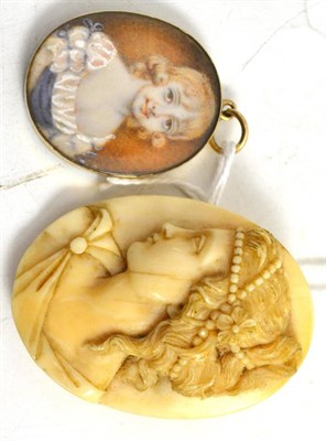 Lot 409 - Edwardian carved ivory portrait brooch of a classical maiden and portrait miniature of a young girl