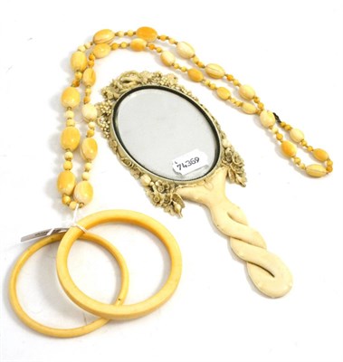 Lot 420 - Edwardian carved ivory bead necklace, two bangles and hand mirror with carved ivory mount