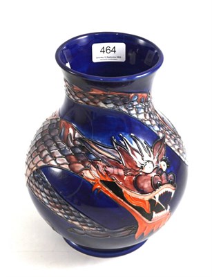 Lot 464 - Modern William John Moorcroft Dragon pattern vase, designed by Trevor Critchlow, on a blue...