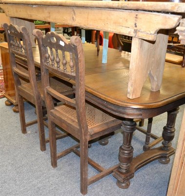 Lot 1020 - Continental oak dining table and four rush seated chairs