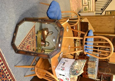 Lot 1033 - Ercol drop leaf kitchen table, four stick back chairs and an oak framed wall mirror