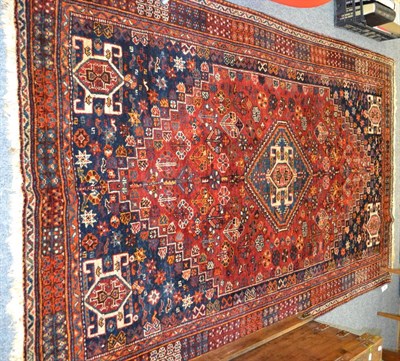 Lot 1038 - Kashgai rug, South West Persia, the stepped madder field with indigo medallion framed by...