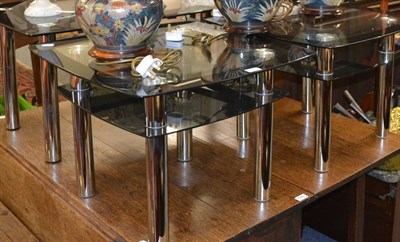 Lot 1041 - Pair of modern black and clear glass side tables on tubular chrome supports