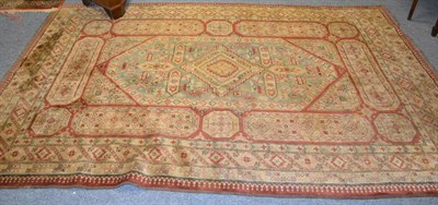 Lot 1066 - An Afghan rug, the brick red field with central lozenges enclosed by multiple borders