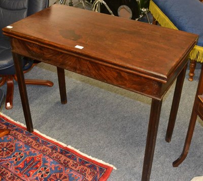 Lot 1125 - George III mahogany fold-over tea table raised on chamfered, channelled legs