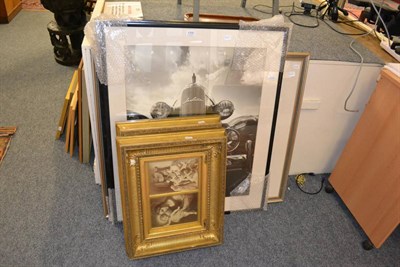 Lot 1200 - A modern watercolour of a coastal scene, two framed posters and a pair of ornate gilt frames