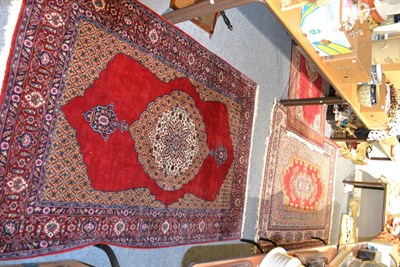 Lot 1212 - Kashan design rug, the blood red field centred by a medallion framed by spandrels and floral...