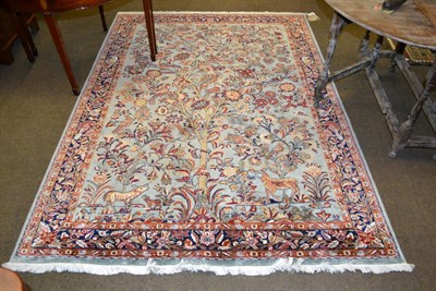 Lot 1323 - Artificial silk, machine made rug of Oriental design, the ice blue field with tree of life...