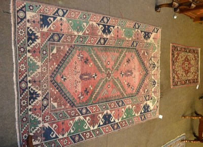 Lot 1355 - Yagibedir rug, West Turkey, the rose field with two hooked medallions enclosed by reciprocal...