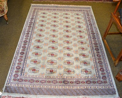 Lot 1383 - Artificial silk machine made rug of Turkoman design, the ice blue field with four rows of quartered