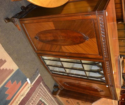 Lot 1422 - Early 20th century bow front china cabinet with central glazed door