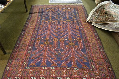 Lot 1479 - Afghan Soumakh carpet, the deep indigo field of stylised flowering plants enclosed by borders...