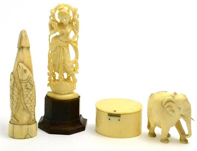 Lot 83 - A Scrimshaw whale tooth carved with fish, an Ivory deity, a box with squeeze action top and an...