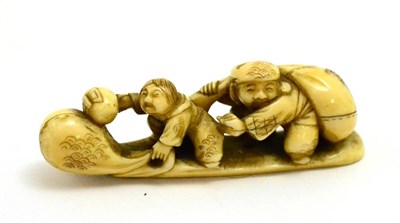 Lot 85 - A Japanese Meiji period netsuke carved as two figures on a naturalistic base, signed
