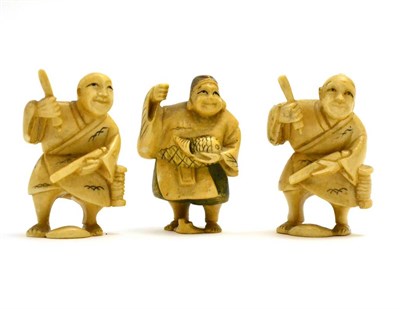 Lot 87 - A group of three Japanese Meiji period ivory netsukes each caved as a street vendor