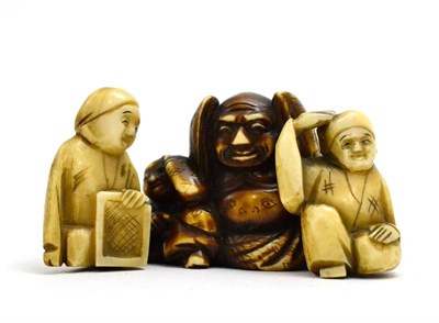 Lot 97 - A group of three early 20th century Japanese ivory netsukes including Buddha, and two others