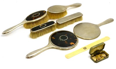 Lot 105 - A three piece tortoiseshell backed silver dressing table set including two brushes and a hand...