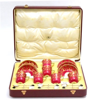 Lot 137 - A six piece Royal Doulton red and gilt coffee service and six silver coffee spoons, Sheffield 1922