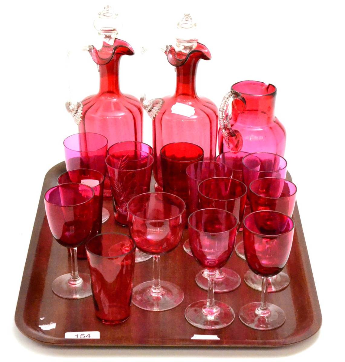 Lot 154 - Collection of predominantly 19th century cranberry glass including pair of decanters, jug, wine...