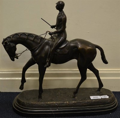 Lot 255 - A bronzed model of a horse and jockey on a marble plinth base