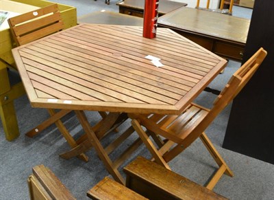 Lot 559 - A teak garden table and two chairs