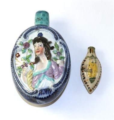 Lot 166 - A Pearlware Flask, circa 1800, of oval form, moulded and painted with busts of Ceres holding a...
