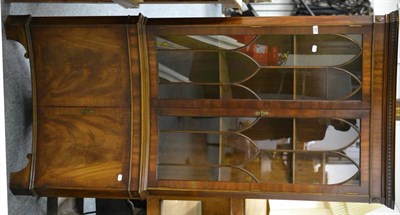 Lot 657 - A reproduction mahogany concave glazed standing corner cabinet