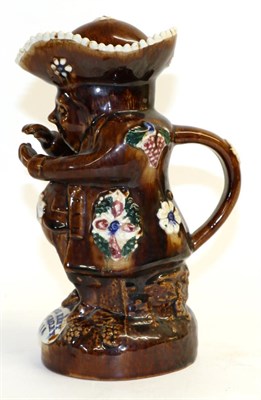 Lot 179 - A Measham Bargeware Toby Jug and Cover, dated 1892, as the snuff-taker, applied with flowers...