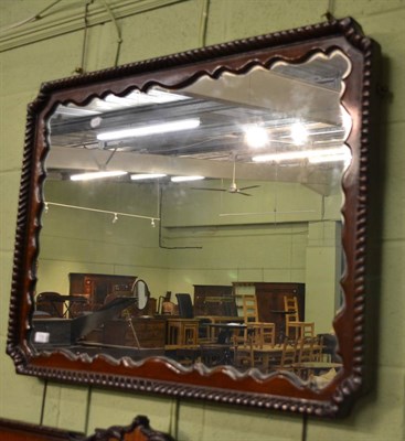 Lot 718 - A large rectangular mirror with gadrooned framed and shaped slip together with a matching...