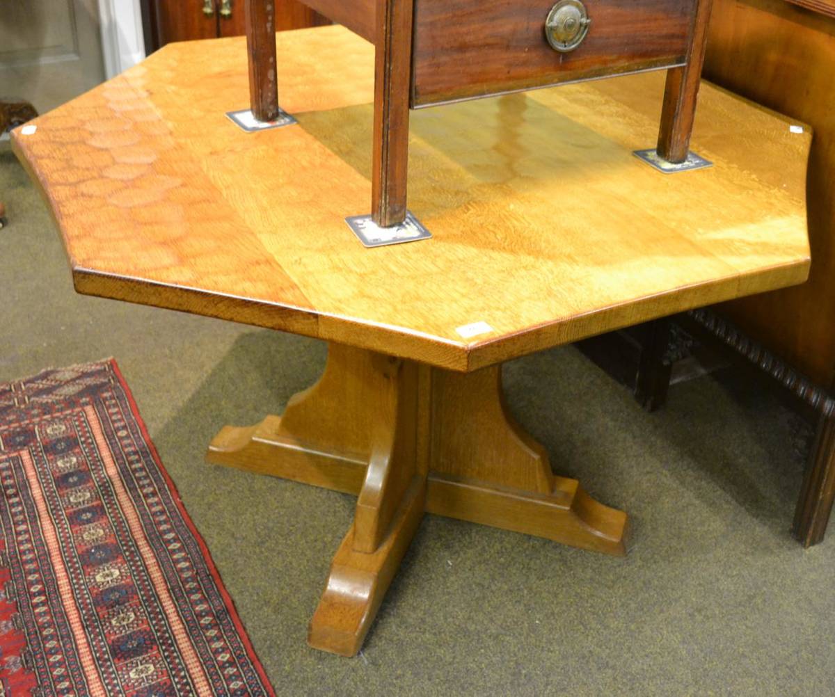 Lot 749 - An Old Mill Furniture 4ft five plank oak octagonal table on cruciform base with recessed carved...