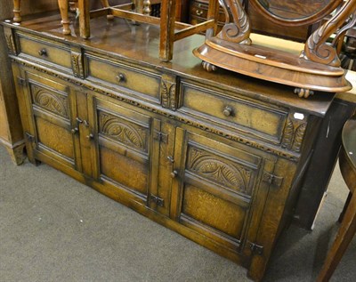 Lot 758 - An early 20th century oak sideboard, the three frieze drawers each fitted and with green baize...