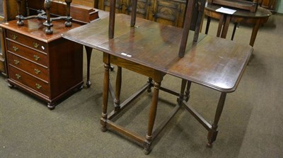 Lot 764 - An oak drop leaf table and an oak work table with hinged cover and stretcher base