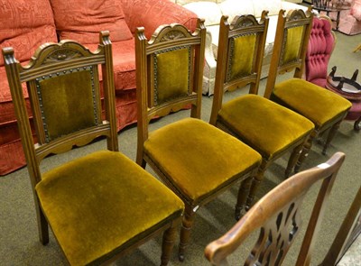 Lot 800 - A set of four late Victorian carved oak dining chairs with upholstered seats and back