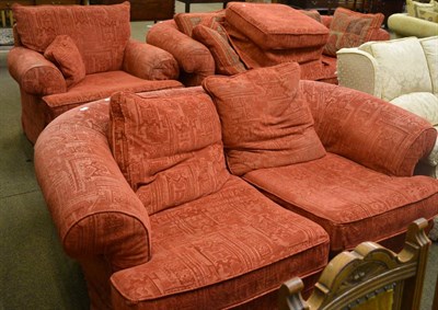 Lot 803 - A red upholstered three piece suite comprising four seater sofa, two seater sofa, armchair and...