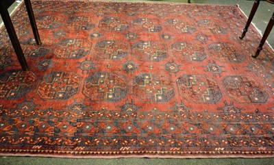 Lot 804 - A Persian carpet, North Afghanistan, the madder field with three columns of elephant foot guls...