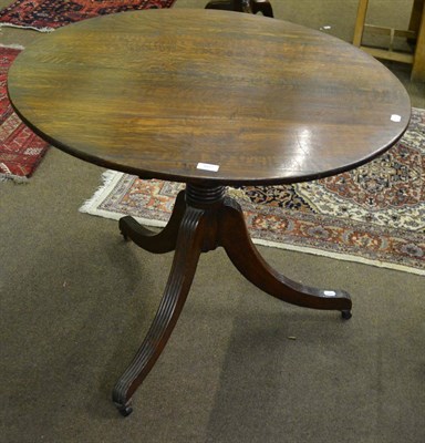 Lot 807 - 19th century oak tripod table on reeded legs