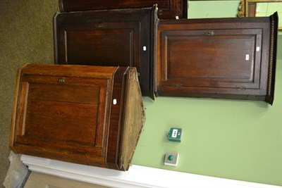 Lot 831 - George III oak hanging corner cupboard the panelled door with central shell patera, together...