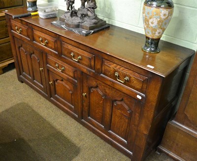 Lot 852 - A modern oak dresser base with four drawers and cupboards below