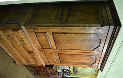 Lot 853 - An oak gent's dressing chest with two cupboard doors over three drawers