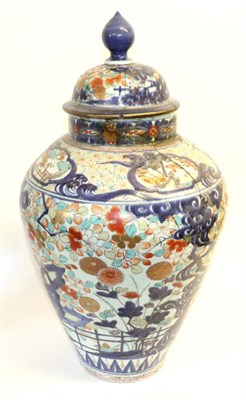 Lot 199 - An Imari Porcelain Jar and Cover, circa 1700, typically painted with a fenced garden within foliate