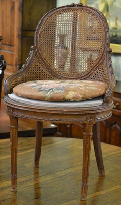 Lot 869 - A caned desk chair with replacement seat and squab