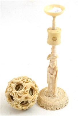 Lot 56 - An early 20th century Chinese ivory puzzle ball and stand, the ball carved in high relief with...