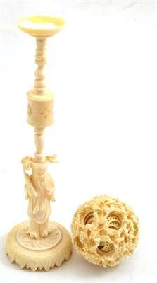 Lot 57 - An early 20th century Chinese ivory puzzle ball and stand, the ball carved in high relief with...