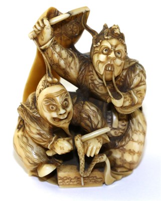 Lot 209 - A Japanese Ivory Netsuke, Meiji period, as two actors wearing Noh masks and holding a banner,...