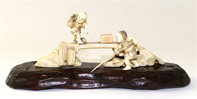 Lot 211 - A Japanese Ivory Bridge Group, Meiji period, as two fishermen on a small bridge, one with a...