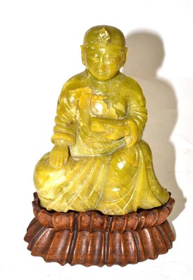 Lot 98 - A soapstone Buddha on wood stand